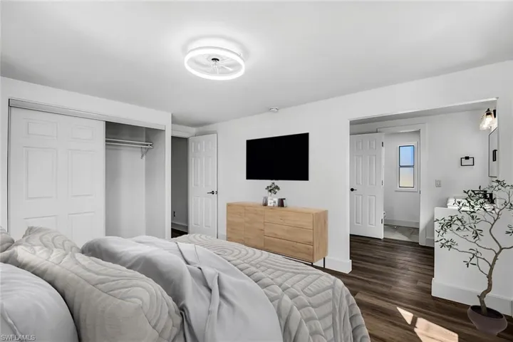 Bedroom featuring dark wood-type flooring and a closet