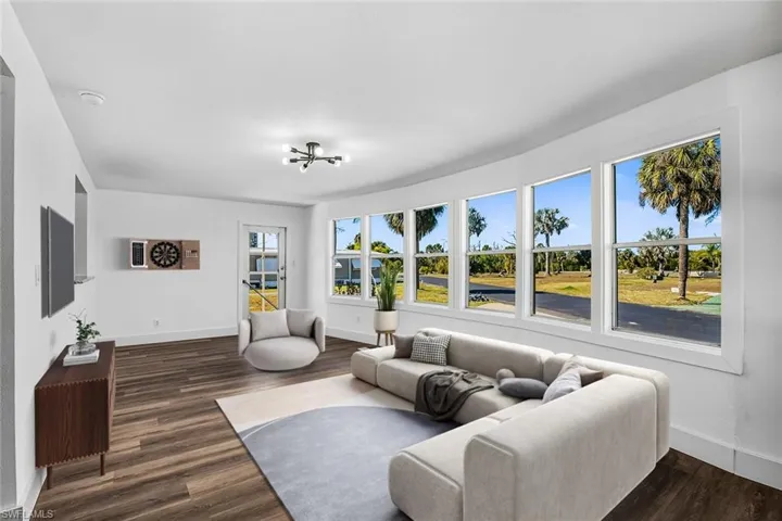 Living area with dark wood finished floors and a chandelier