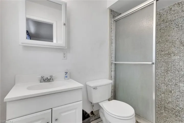 Bathroom featuring a shower stall and vanity