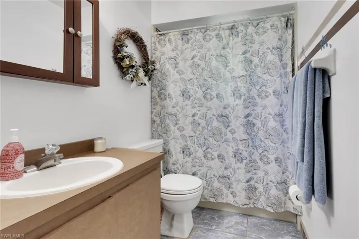 Bathroom featuring vanity and a shower with shower curtain
