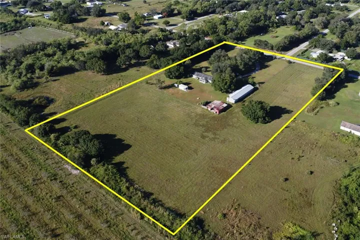 Overview of rural landscape featuring property parcel outlined and large plots for crops
