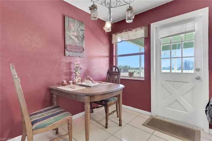Dining space featuring a textured wall and tile patterned floors