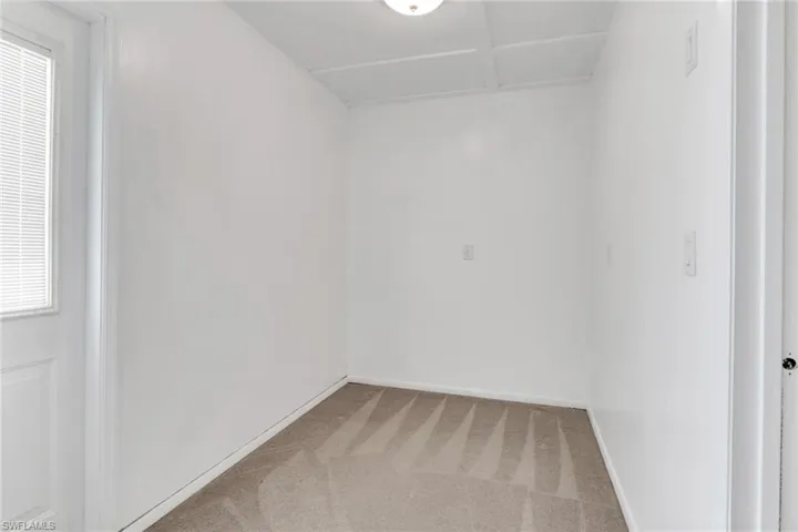 Carpeted spare room with baseboards