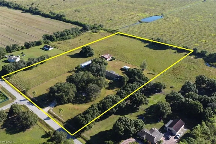 Overview of rural landscape featuring property boundaries highlighted and large plots for crops