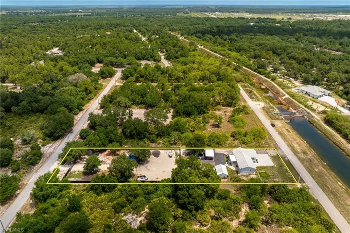 Bird's eye view of a heavily wooded area and a large body of water