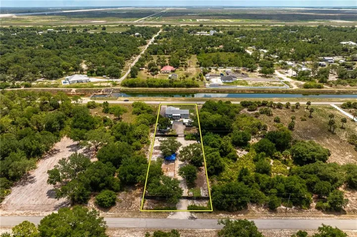 Aerial overview of property's location featuring a nearby body of water and property boundaries highlighted