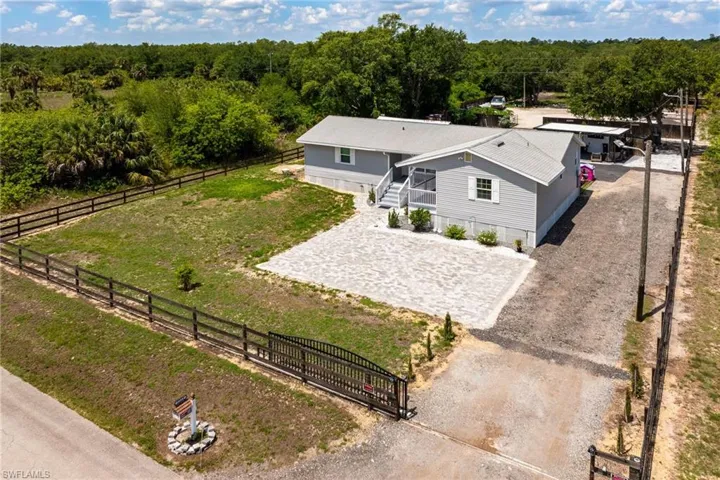 Aerial view of property and surrounding area featuring a heavily wooded area