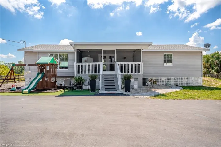 View of front of home with a sunroom