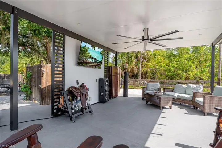 View of patio with an outdoor living space and a ceiling fan