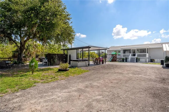 Back of house featuring a playground and a sunroom