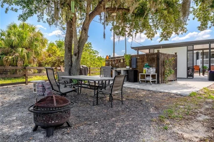 View of patio / terrace featuring an outdoor fire pit and outdoor dining area