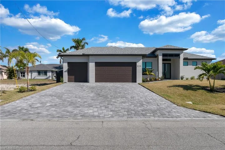 Prairie-style home with a garage and a front lawn