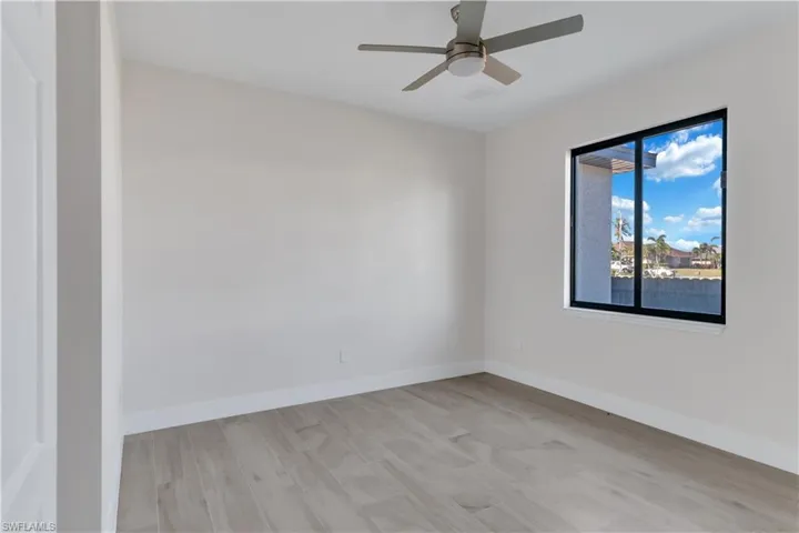 Unfurnished room featuring light hardwood / wood-style floors and ceiling fan