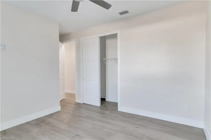 Unfurnished bedroom featuring a closet, ceiling fan, and light hardwood / wood-style floors