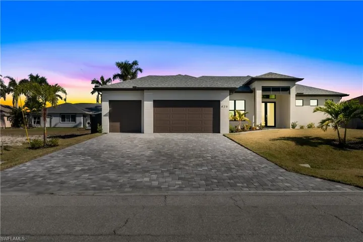 Prairie-style house featuring a yard and a garage