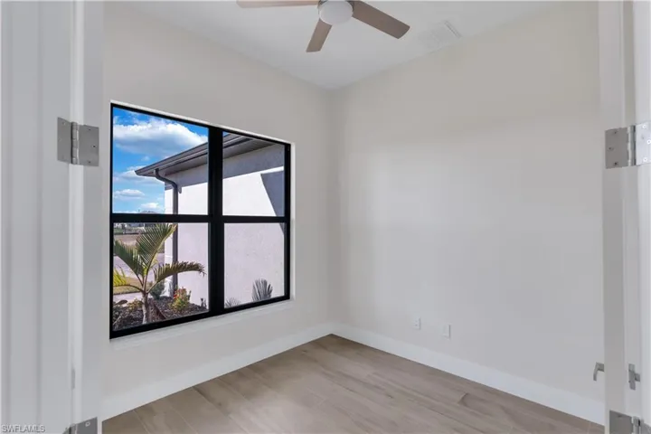 Empty room with light hardwood / wood-style flooring and ceiling fan