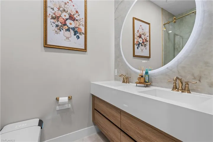 Full bath featuring toilet and double vanity