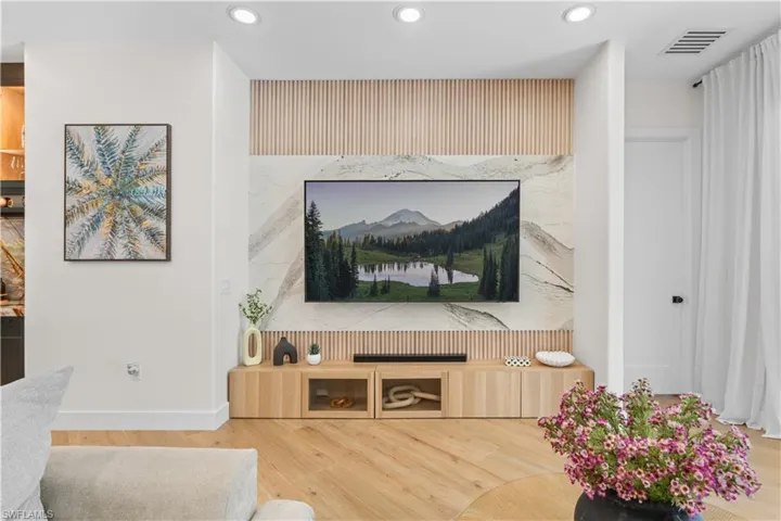 Living room with recessed lighting and wood finished floors