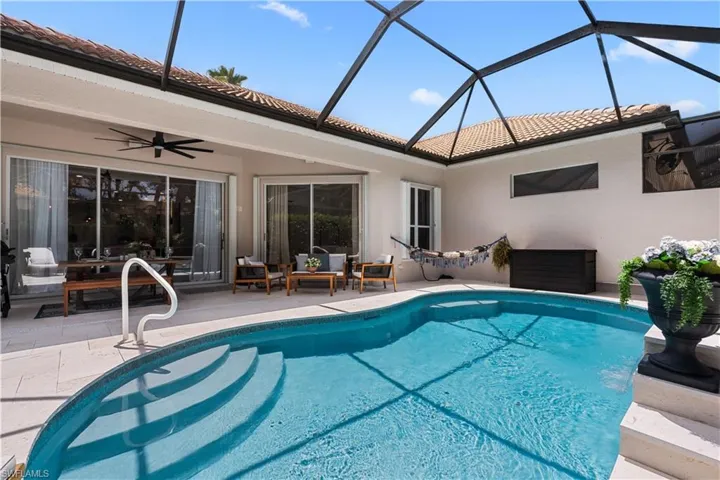 Outdoor pool with a patio, a ceiling fan, a lanai, and outdoor lounge area