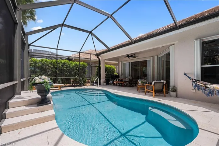 Outdoor pool with a patio area, a lanai, and a ceiling fan