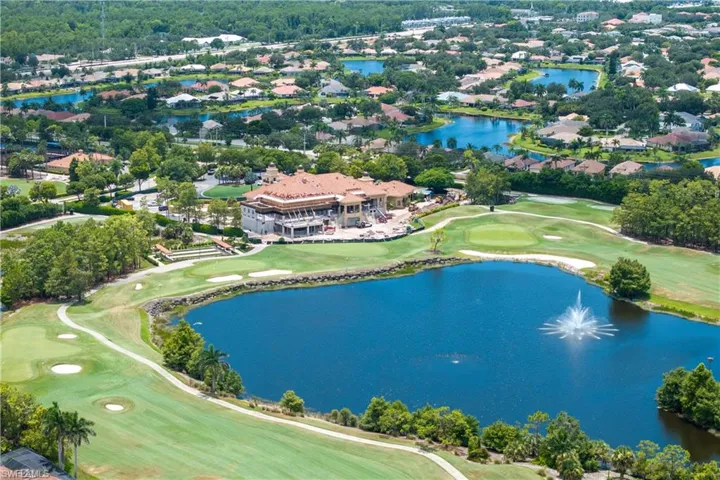 Aerial perspective of suburban area with a golf club and a nearby body of water