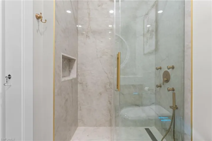 Bathroom featuring a marble finish shower