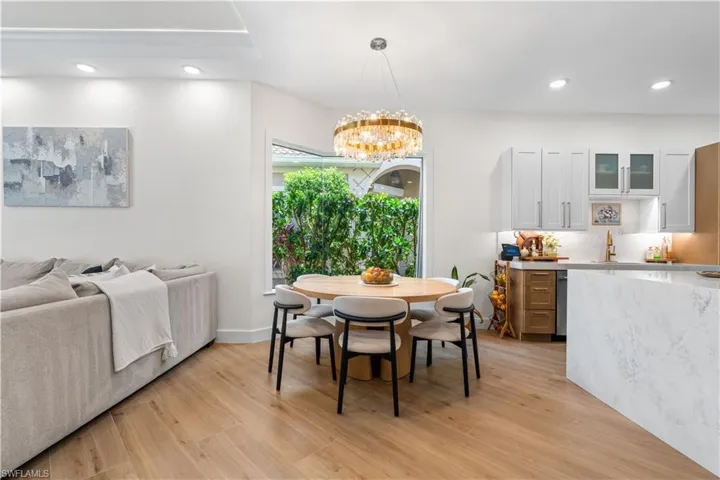 Dining space with recessed lighting, light wood-style flooring, and a chandelier