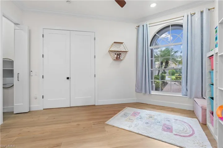 Bedroom with crown molding, light wood-style floors, ceiling fan, and recessed lighting