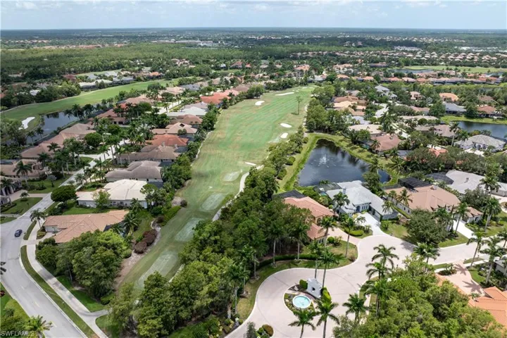 Aerial overview of property's location with nearby suburban area, a large body of water, and a golf course