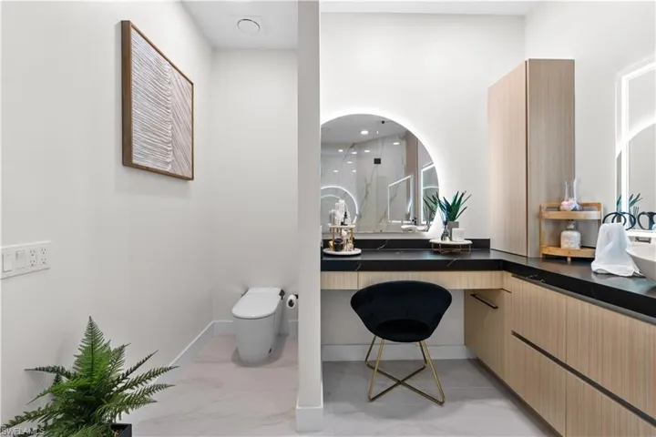 Full bath with vanity, marble finish flooring, a shower, and recessed lighting