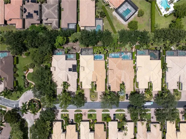 Aerial view of property and surrounding area featuring nearby suburban area