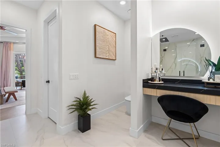 Full bathroom with marble finish flooring, a marble finish shower, vanity, and ceiling fan