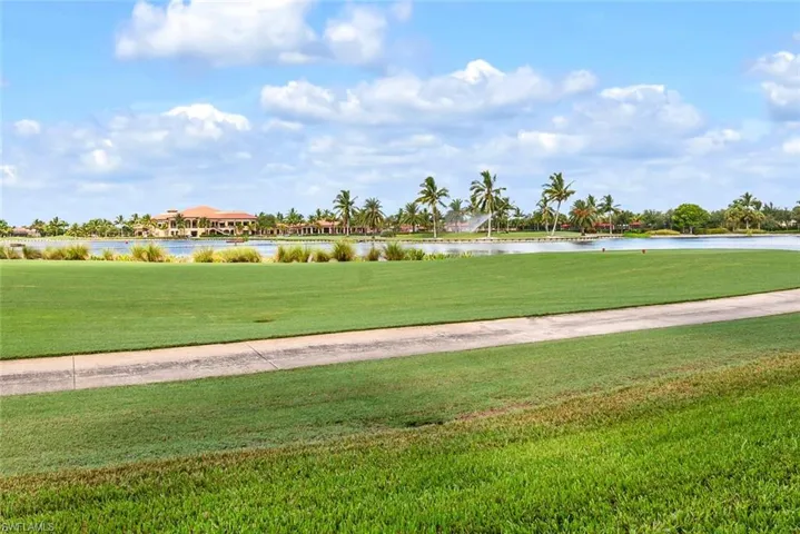 View of home's community featuring a lawn and a water view