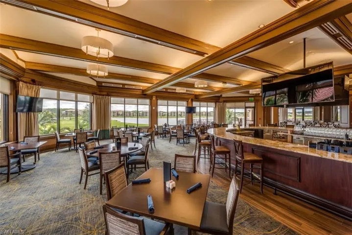 Dining area featuring beamed ceiling and dark wood-type flooring