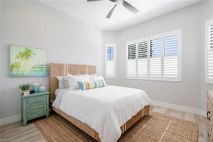 Bedroom with ceiling fan and light wood-type flooring