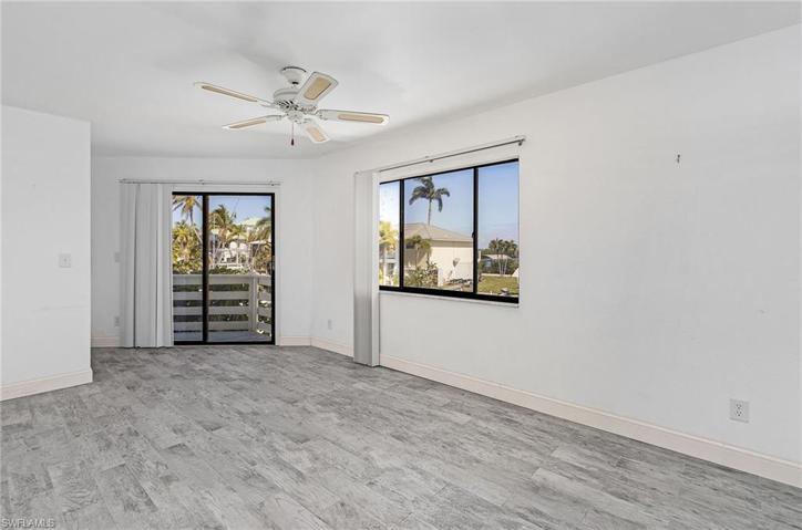 Second floor bedroom with sliders to balcony.