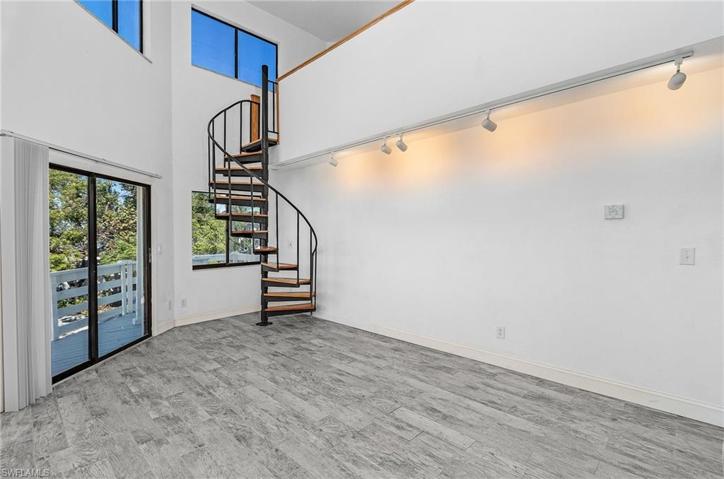 Living room with sliders to 2nd floor balcony.
