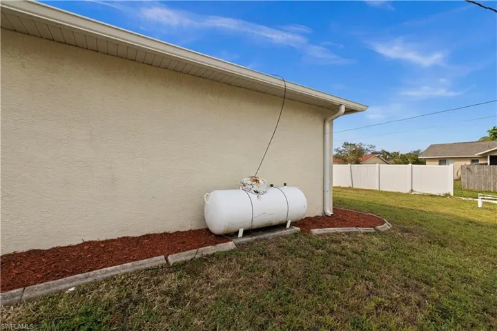 View of property exterior with a lawn