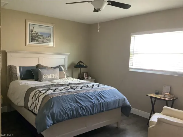 Bedroom featuring ceiling fan and dark wood finished floors