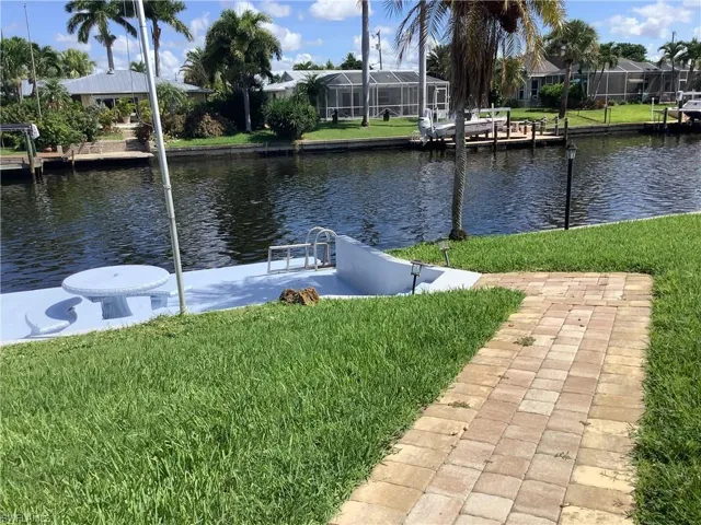 Dock featuring a yard and a water view