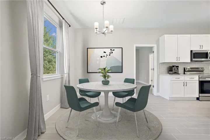 Tiled dining area with a chandelier