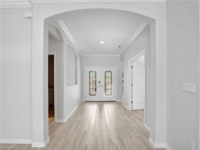 Grand, bright Foyer with beautiful doors