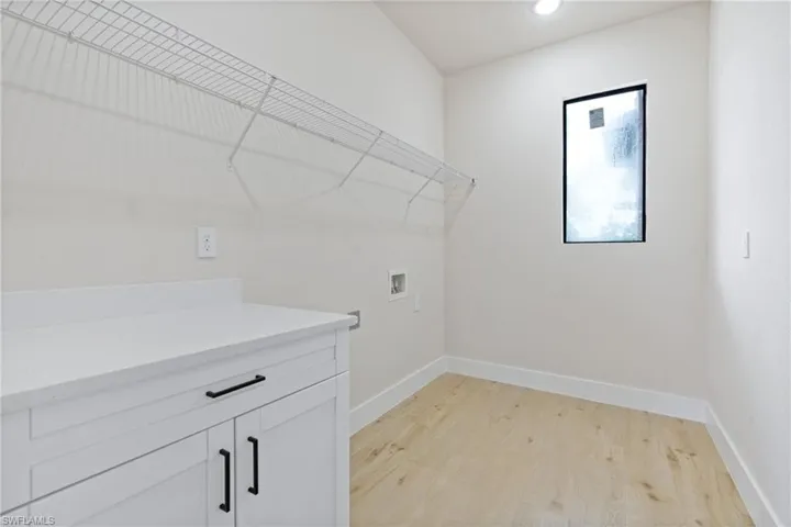 Laundry room with hookup for a washing machine, and cabinets