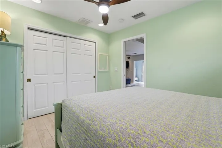 Bedroom featuring wood finished floors, ceiling fan, and a closet