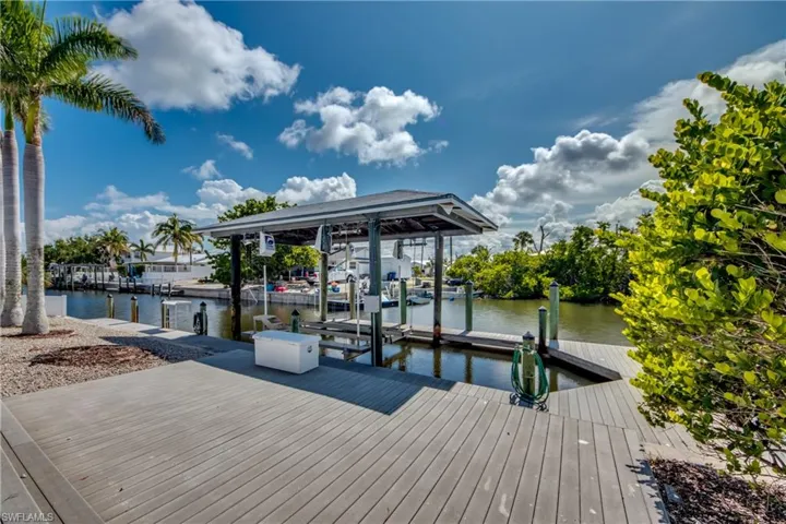 Dock area with boat lift and a water view