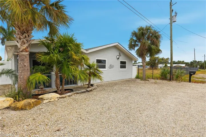 View of property exterior featuring gravel driveway