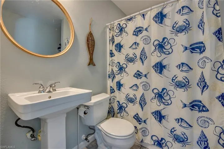 Full bath featuring toilet and a shower with shower curtain