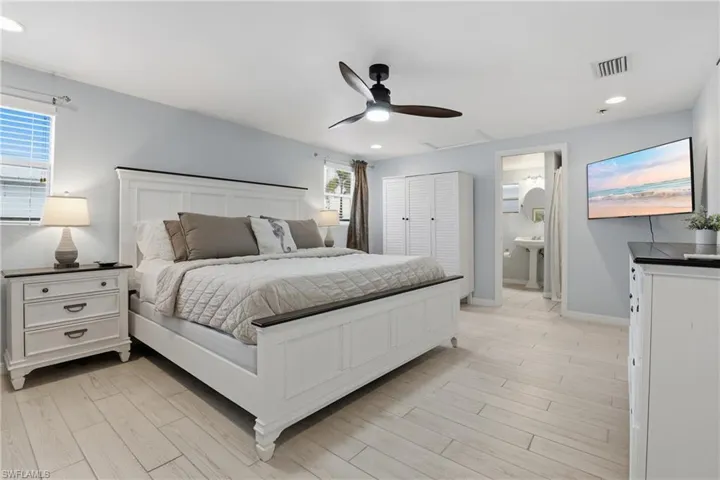 Bedroom with a closet, light wood finished floors, ceiling fan, and recessed lighting
