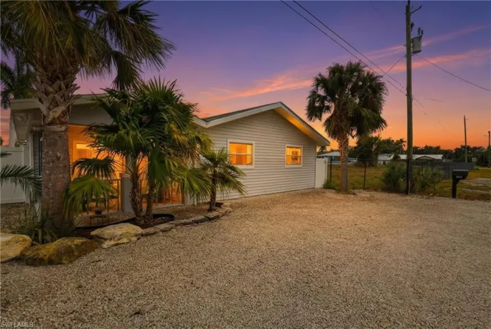 Property exterior at dusk with gravel driveway