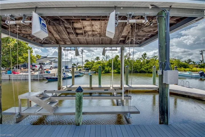 Dock area featuring boat lift and a water view